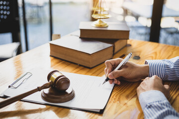 Lawyer working in a law office reading agreement contract documents and signing, Sign the auction...