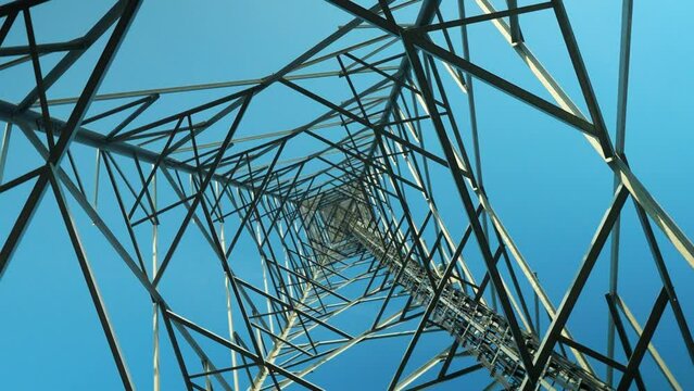 4K footage of transmission tower from underneath. Shooting from below with rotation and vortex movement stock video.