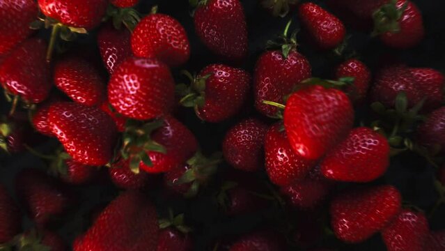 Strawberry background is jumping. Fresh juicy strawberries bouncing. Slow motion close up