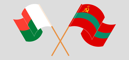 Crossed and waving flags of Madagascar and Transnistria