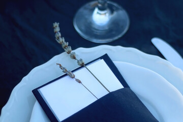 Table setting with white and blue dishes, candles and lavender flowers. Rustic Mediterranean style....