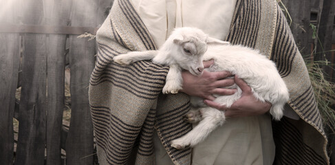 Shepherd with a sheep in his arms