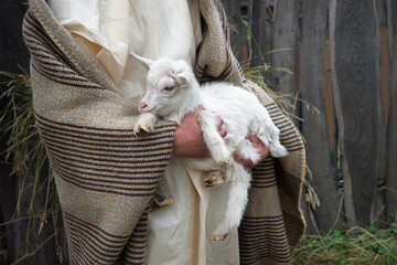 Shepherd with a sheep in his arms