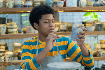 Crafting memories, Boys shaping clay into beautiful pottery in the workshop.