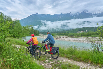 active senior couple  on a e-bike tour in the Valley of River Soca, Triglav National Park near Bovec, Slovenia