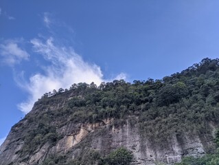 rock hill with grass ( Bangluru) isolated on sky background. the name of this hill is the Indonesian harau hill