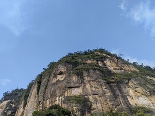 rock hill with grass ( Bangluru) isolated on sky background. the name of this hill is the Indonesian harau hill