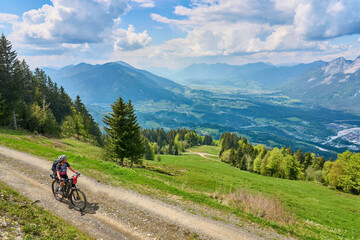 Fototapeta na wymiar active senior woman on a mountain bike tour in the carinthian alps above Villach in Austria