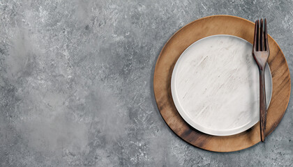 Top View Plate and Stainless-Steel Fork with Wooden Handle on Grunge Grey Background for dining,...