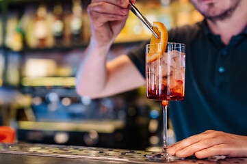 man hand bartender making cocktail in glass on the bar counter