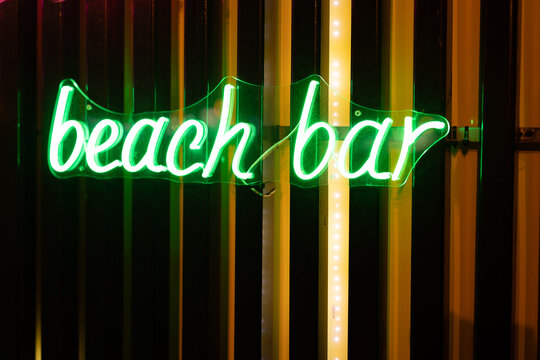 Neon signboard beach bar close-up. - Powered by Adobe