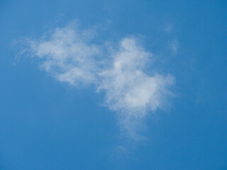 Photo of a blue sky with a white cloud