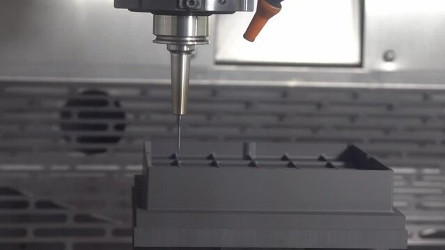 The CNC milling machine finish cutting the graphite electrode parts with solid ball end mill.