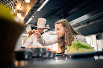 cooking under the guidance of seasoned chefs at a culinary school's kitchen.