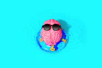Brain Character in Sunglasses Floats on an Inflatable Tube