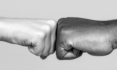 Black african american race male and woman hands giving a fist bump. Black and white
