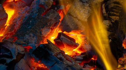 Fototapeta premium Fire in the fireplace. Aged wood smells wonderful, so if you're going to burn it, choose logs for the smoky, musky smell. Use kiln-dried logs to show your love for the environment.