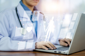 Doctor using computer working in hospital, Doctor using computer checking data patient document,...