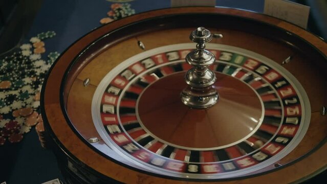 People play roulette in casino, game gold spinning roulette table close up, croupier dealer and roulette in a modern casino. 