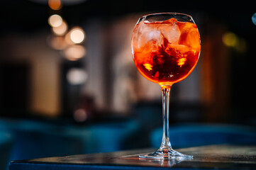 alcoholic cocktail in a glass stands on a table in a bar or restaurant