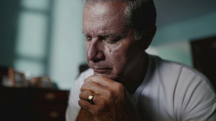Preoccupied older man covering face in shame and anxiety. A male caucasian middle-aged person...