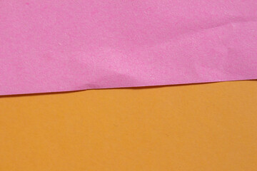 Pink torn paper on orange background. Ripped paper texture with copy space.