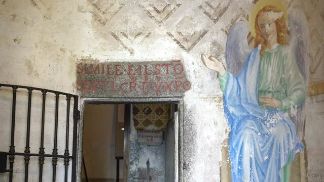 Threshold into the inner sanctum of Holy Sepulchre at Sacred Mountain of Varallo, a christian devotional complex, a unesco world heritage si in Italy. Zoom out 4k footage