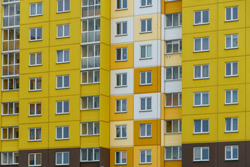 Fototapeta na wymiar Modern residential multi-storey building. Windows and balconies on a new residential building close-up. Buying and selling apartments, rental housing, happy family life in a comfortable apartment.