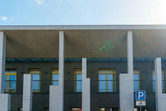 Modern architecture, the building of the Lithuanian Embassy. A fragment of the exterior of a public or office building against a blue sky background. Industrial, technological style of construction.