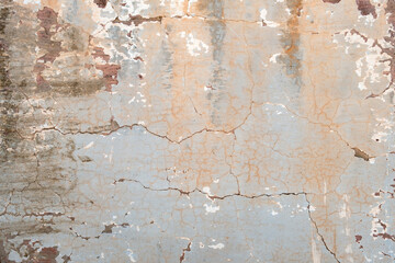 Old cracked wall with worn out blue paint