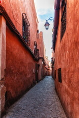 Fototapeta na wymiar A small orange traditional alley in Marrakech, Morocco