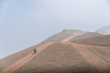 cyclist practicing mountain biking, enduro. nog hills