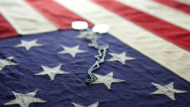 Concept fourth of July, 4th of July, Happy fourth of July USA independence day, celebration, Veteran's Day, Memorial Day, Holiday. Dolly shot of vintage American flag with USA army, military dog tags
