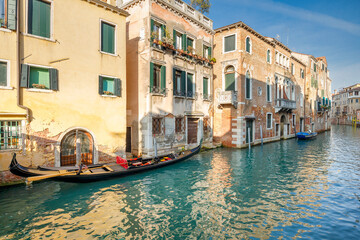 Gondola in a canal of the old town of Venice, Italy, Europe.
