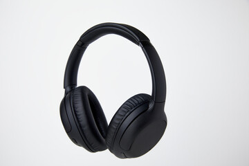 Fototapeta na wymiar Black Wireless Headphones Floating in Studio - Stock Photos.