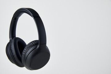 Black Wireless Headphones Floating in Studio - Stock Photos.