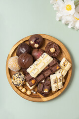 Wooden plate with healthy craft natural candies and mini chocolates. Sweet food, healthy dessert