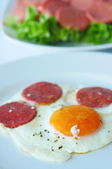 fried egg mixed with sausage on a plate 
