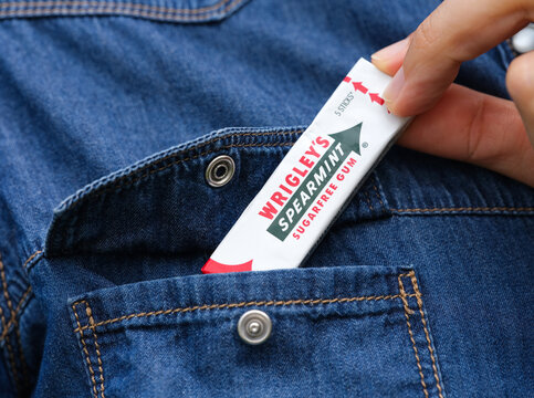 Tambov, Russian Federation - May 12, 2023 A person taking a pack of Wrigley's spearmint gum from a denim jacket pocket