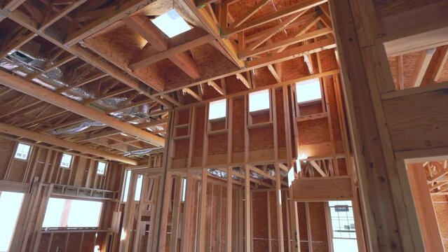New Southwest Home Construction Interior Framing Walk Through Look Up at Ceiling. slow motion view in home construction framing interior move along look up at ceiling