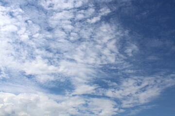 Blue sky background with white clouds.