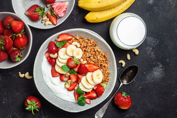 Fototapeta na wymiar Granola with yogurt, strawberry and banana in a bowl