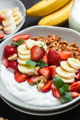 Granola with yogurt, strawberry and banana in a bowl