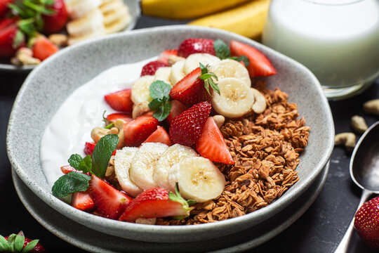 Granola with yogurt, strawberry and banana in a bowl