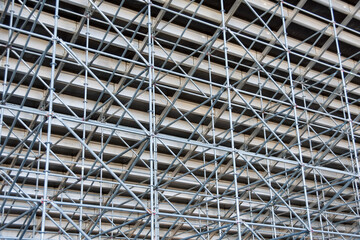Metal pipe frame structure. Industrial construction from tubes raises upwards. Building process and joining elements view. Straight and inclined lines backdrop.