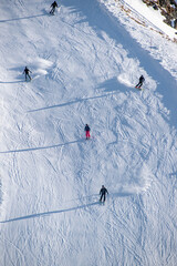 Multiple skiers skiing down a slope on mountain peak, Les Deux Alpes, Isère,...