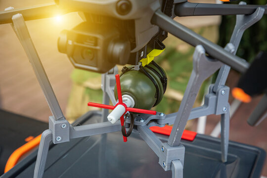 A drone with a grenade. Concept using quadrocopters in smart war. Bombing with drones. Modern warfare in Ukraine.