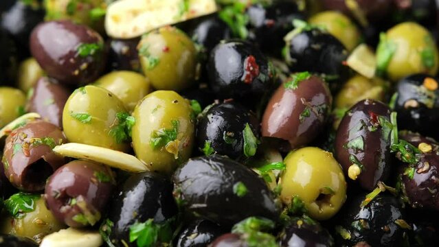 Marinated olives with fresh herbs, garlic, red wine vinegar and lemon zest. Rotating video