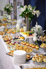 various snacks and drinks at the buffet table at the corporate catering event