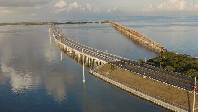 Aerial view of overseas highway 1 bridge in the Florida Keys landscape with shoreline during golden hour sunset - 4K Drone